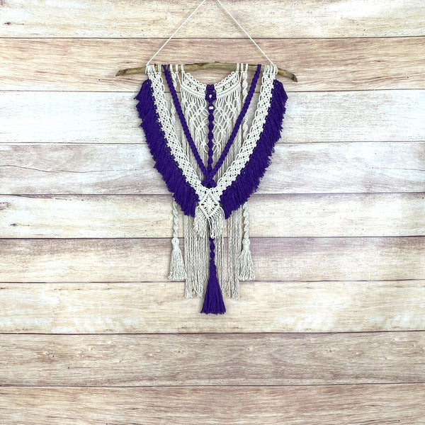 macrame wall hanging with purple fringe and tassels