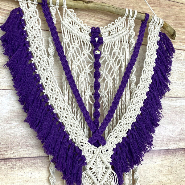 macrame wall hanging with purple fringe and tassels