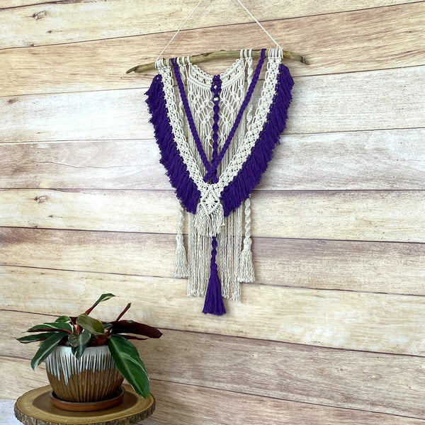 macrame wall hanging with purple fringe and tassels