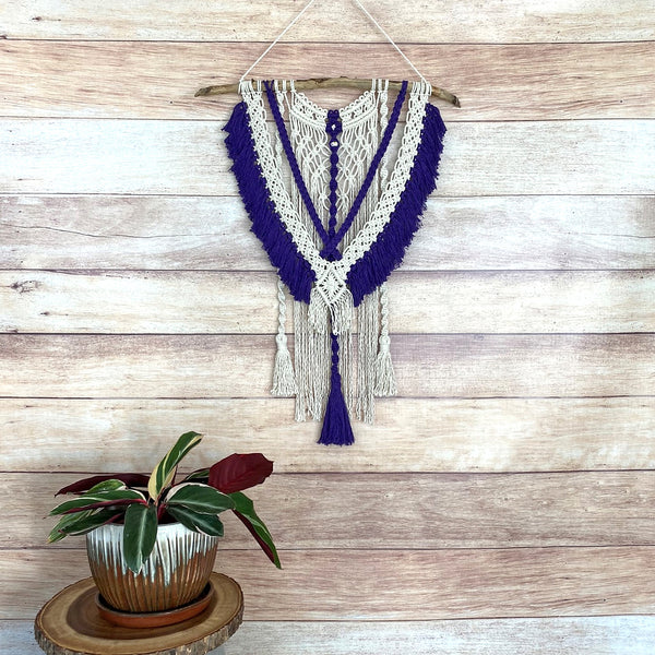 macrame wall hanging with purple fringe and tassels