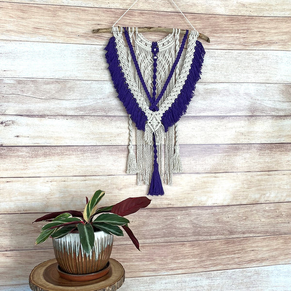 macrame wall hanging with purple fringe and tassels