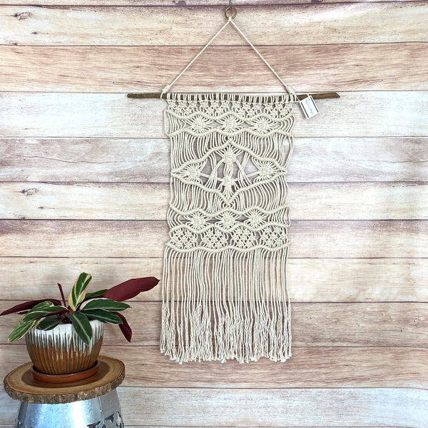 macrame wall hanging on driftwood