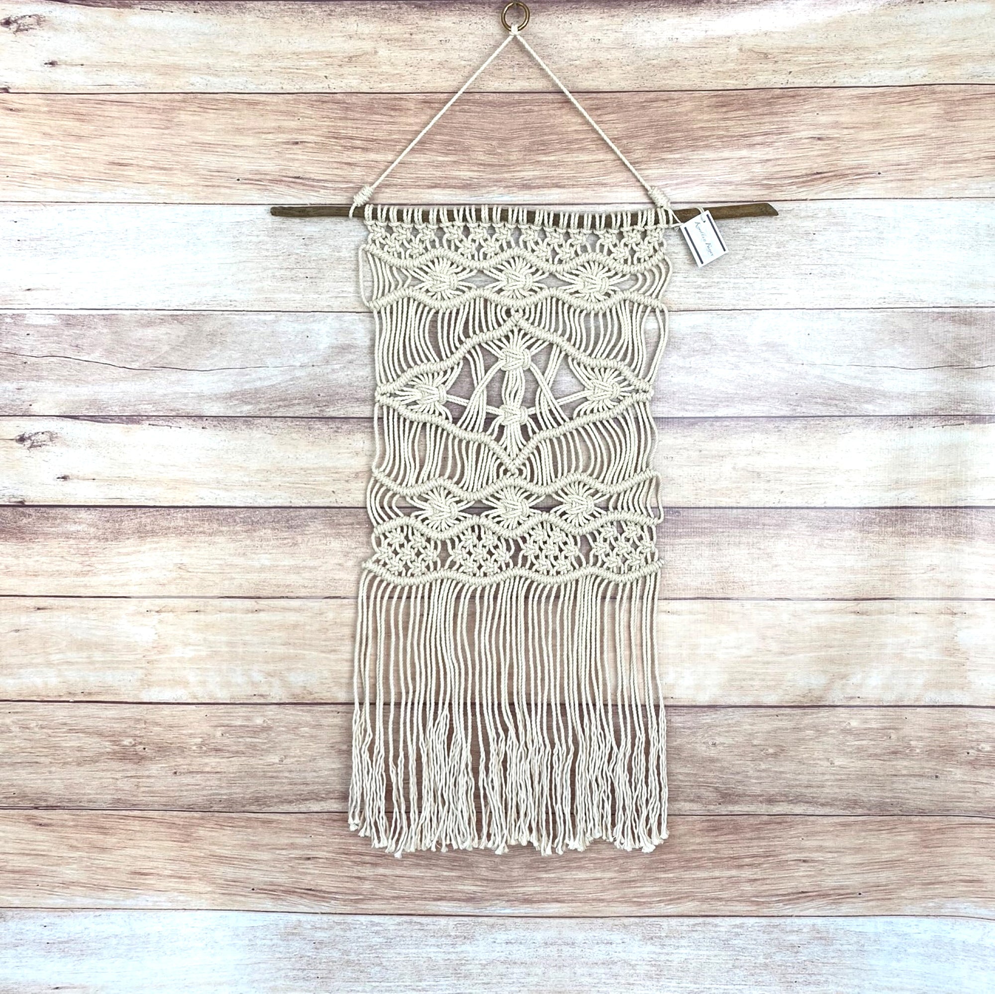 macrame wall hanging on driftwood