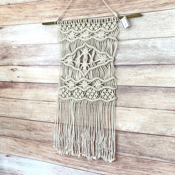 macrame wall hanging on driftwood